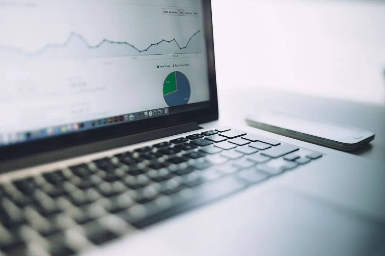 Laptop showing an analytics dashboard with charts and graphs