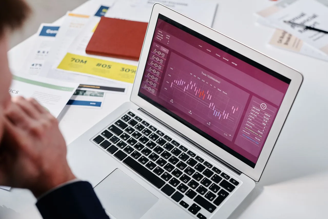 Businessperson reviewing a data chart on a laptop screen in an office