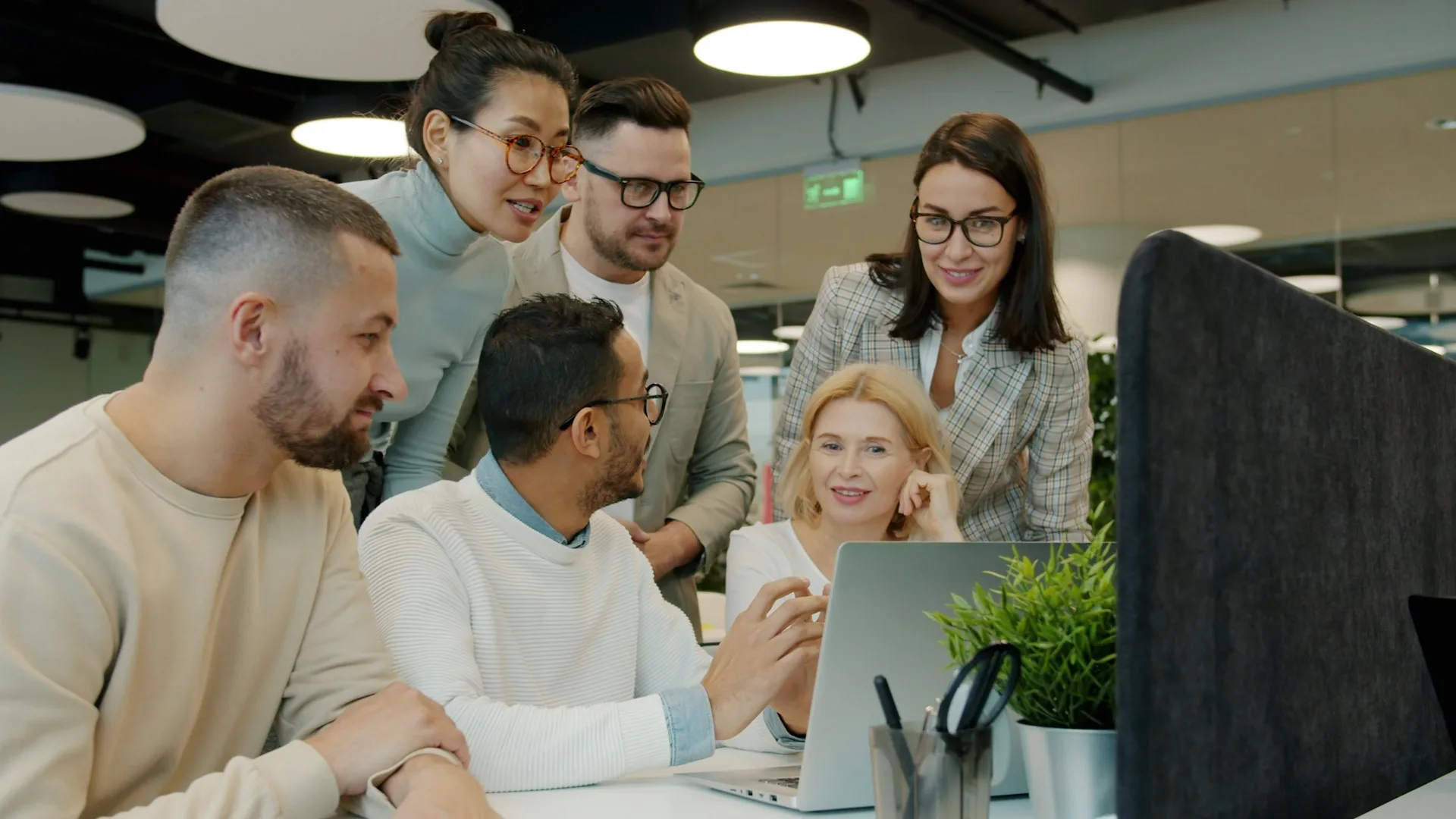 Small business team reviewing a workflow on a laptop.