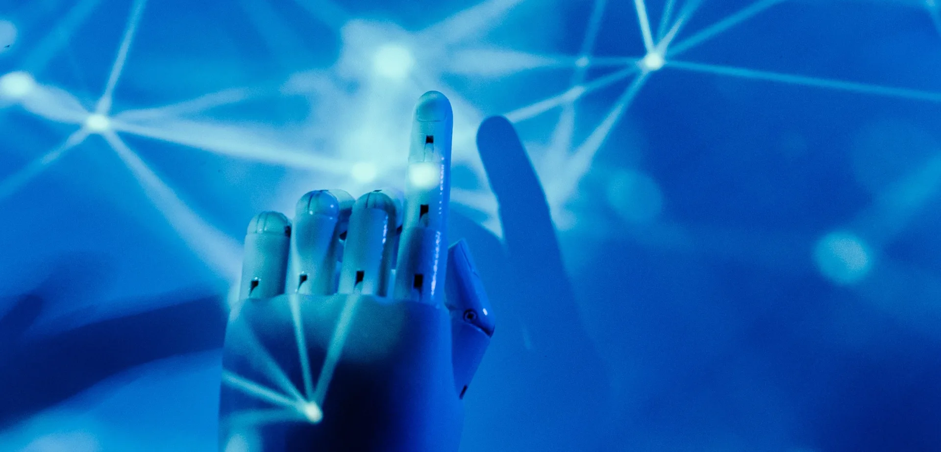 Futuristic robotic hand touching a digital network on a blue background