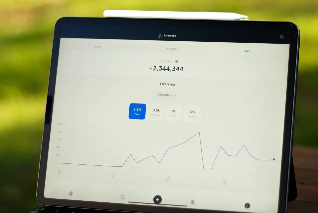 Tablet and laptop displaying a data graph with analytics charts